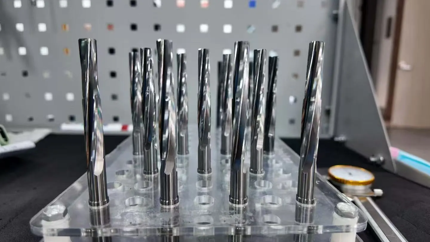 Long custom CNC tools with different cutting profiles arranged for inspection