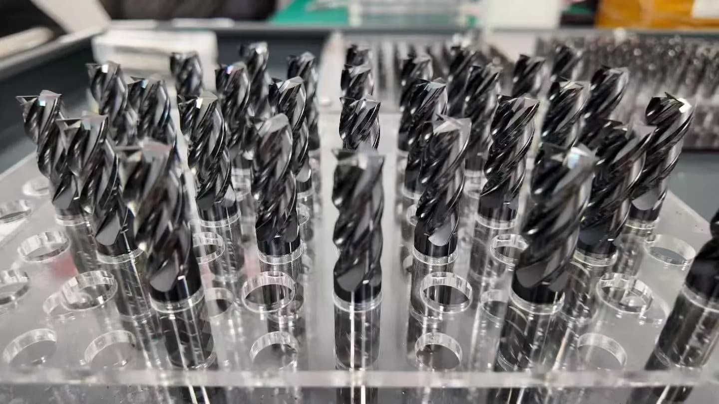 Rows of dark-finish profile cutting tools in clear inspection stands