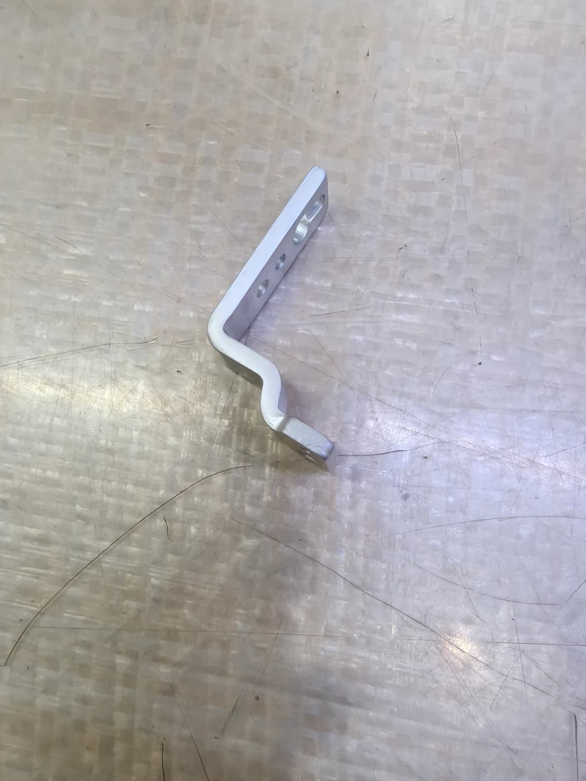 Offset metal bracket with several bends and mounting holes