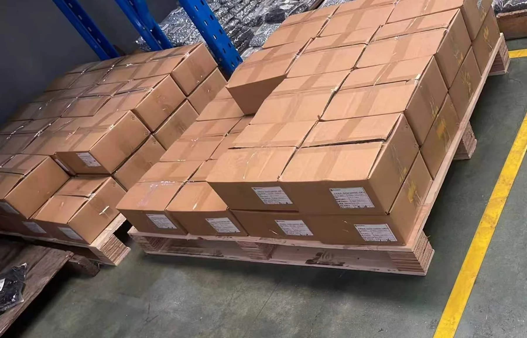 Palletized cartons of steel spacers and countersunk screws prepared for container shipment to Serbia