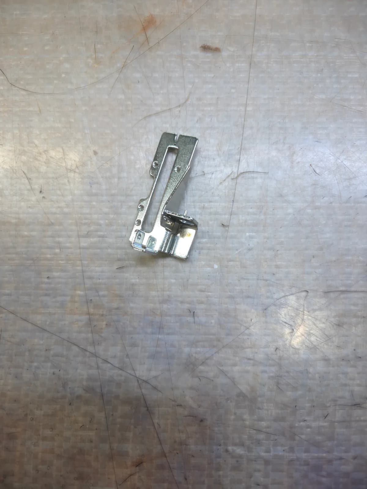 Slotted metal bracket with formed mounting features