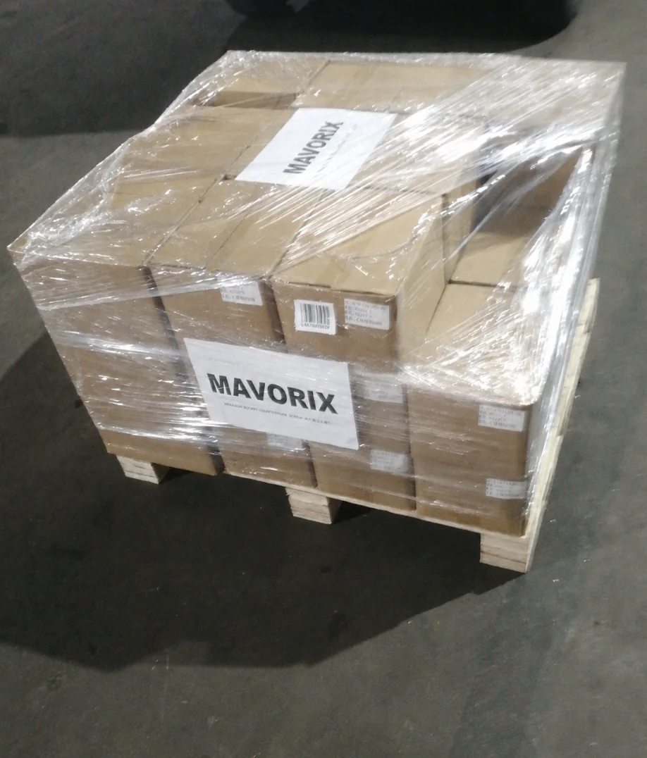 Cartons of stainless steel countersunk screws stretch wrapped on a wooden pallet for shipment to Serbia