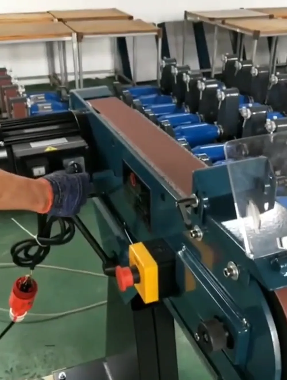 Industrial belt sander workshop testing before shipment