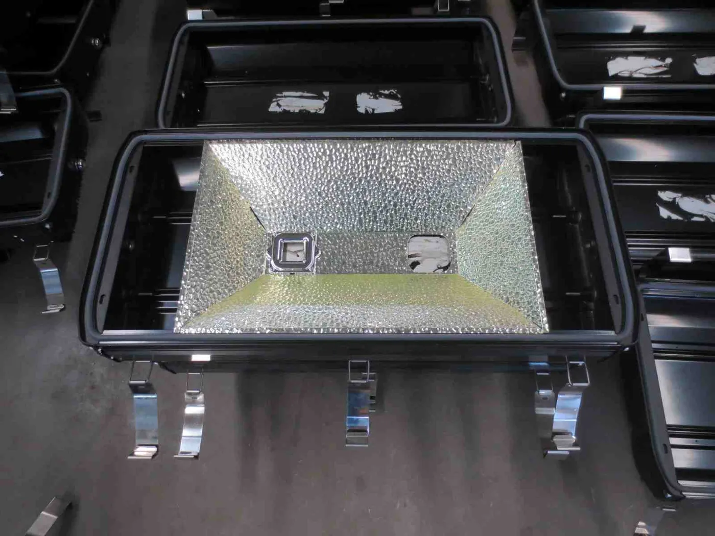 Reflector assembly inside an industrial LED flood light housing